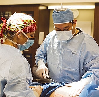 Surgeons performing a procedure in an operating room.
