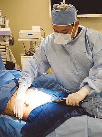 Surgeons performing a procedure in an operating room.