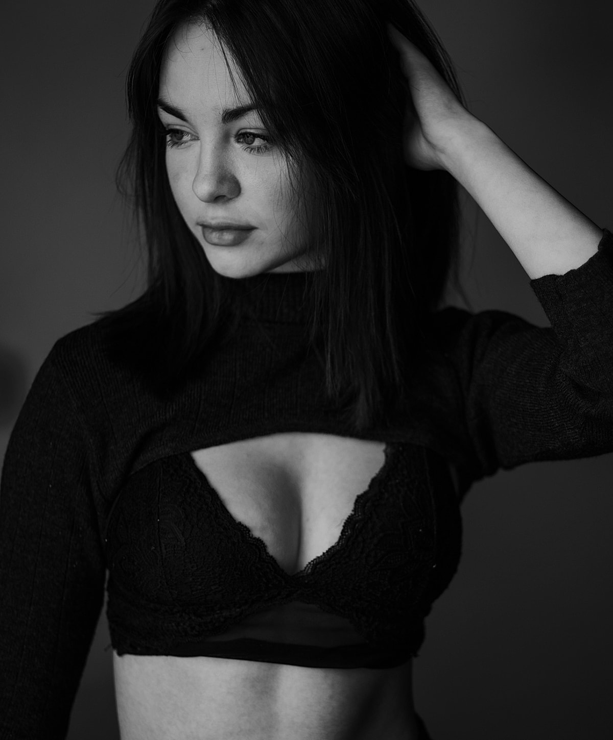 Black and white portrait of a woman thoughtfully posing.