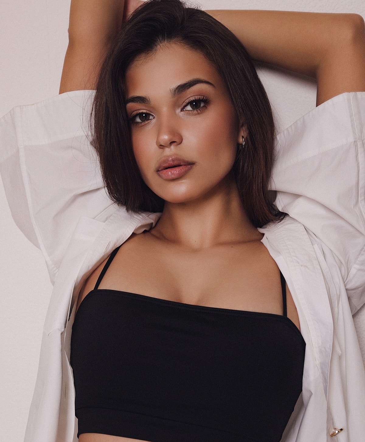 Young woman with brown hair in trendy fashion.