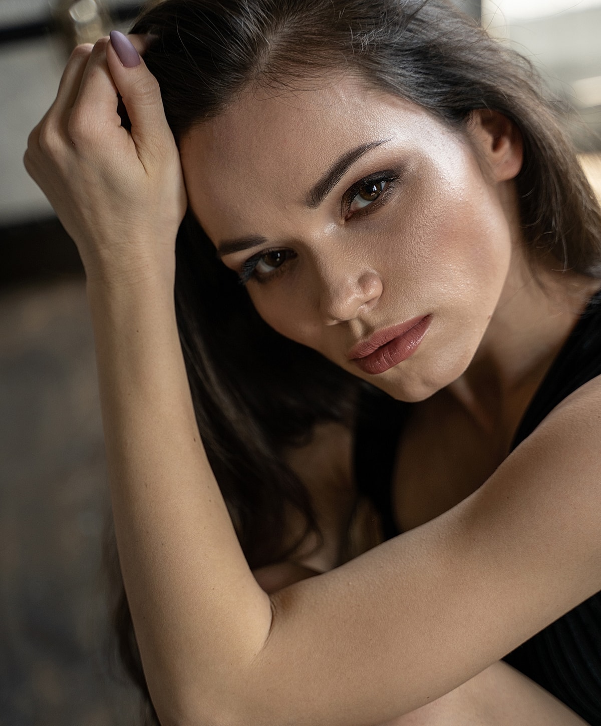 Close-up of a thoughtful woman resting her arm.