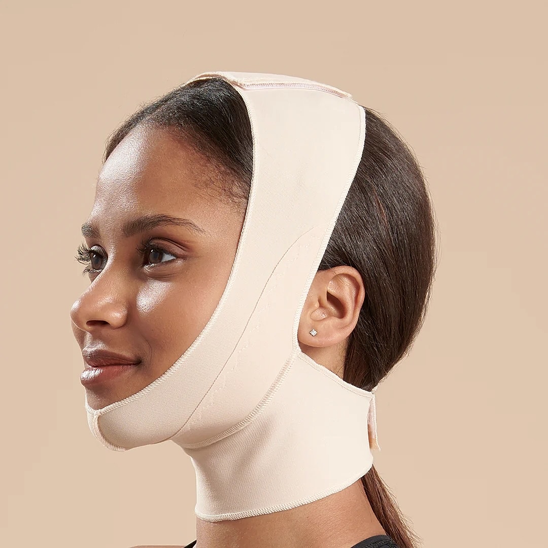Woman wearing a facial compression band.
