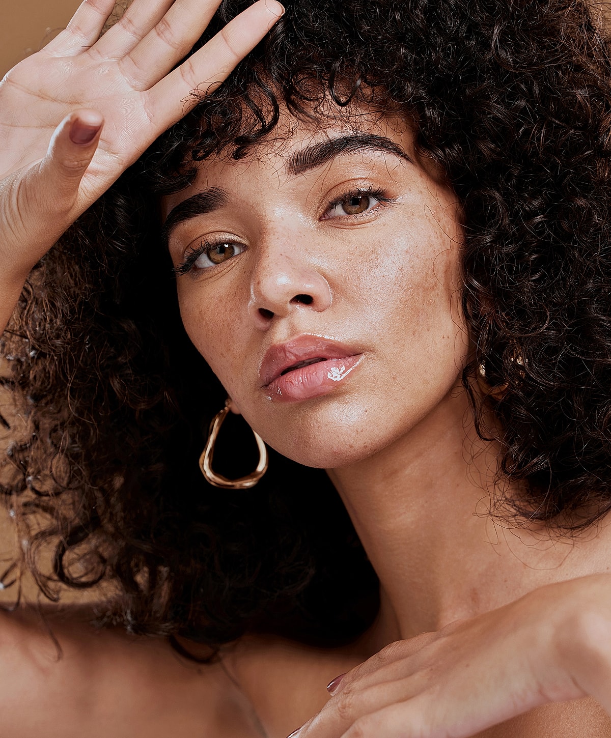 Close-up of a woman with curly hair.