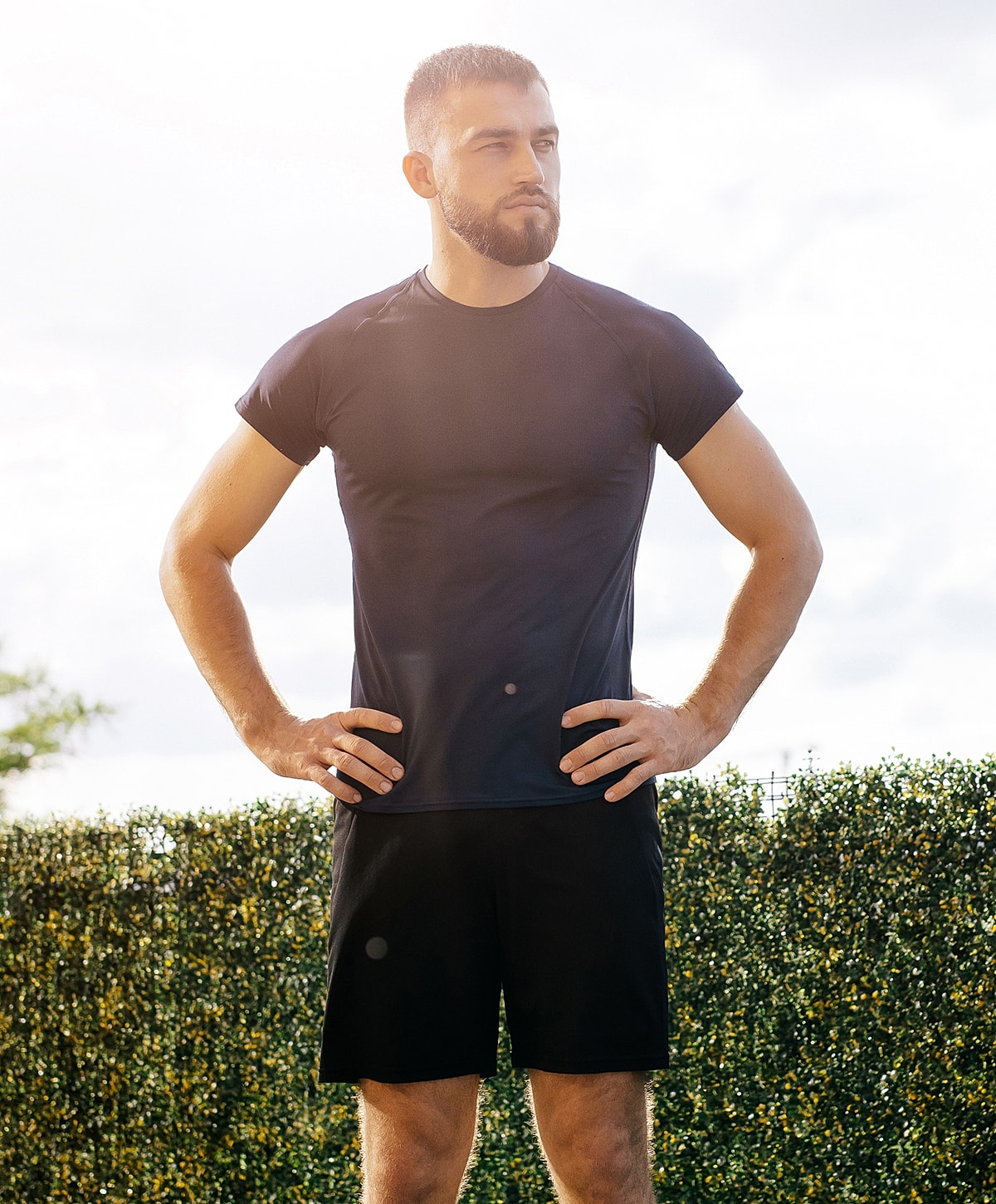 Model in olive green bikini by window