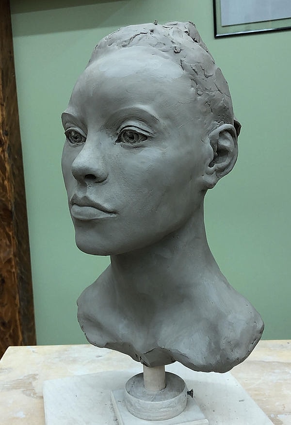 Clay sculpture of a human head bust.