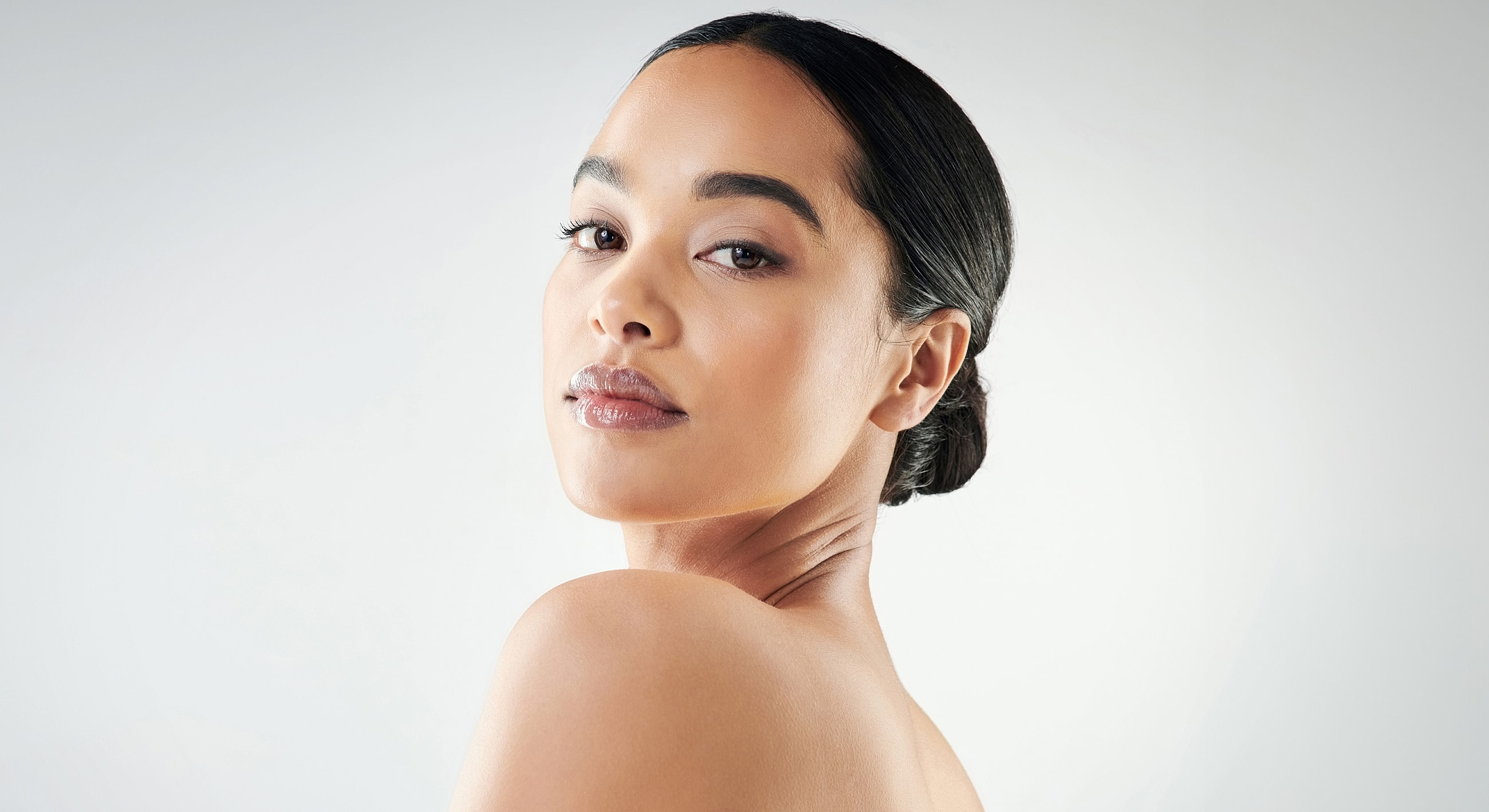 Woman with smooth skin and elegant hairstyle.