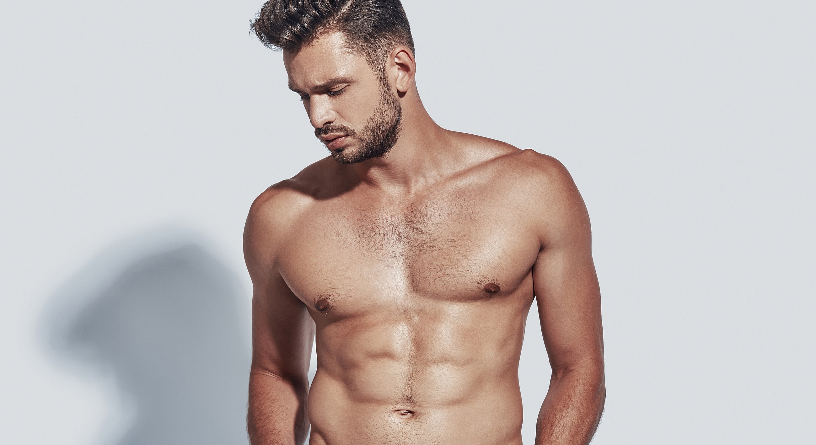 Man posing with a strong physique and expression.