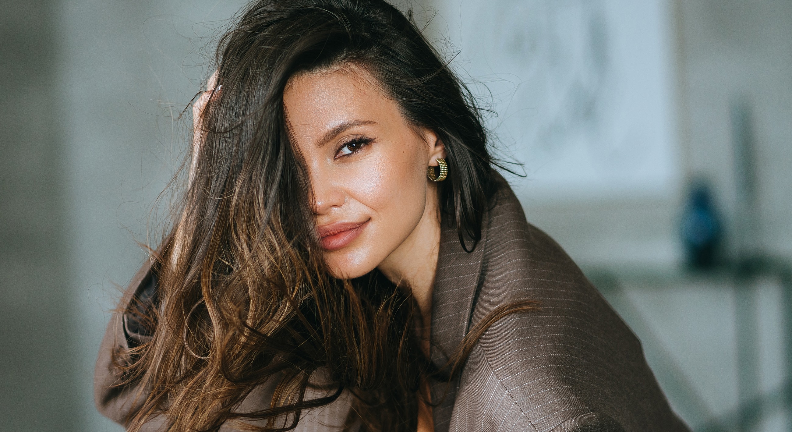 Smiling woman with long hair and black outfit.