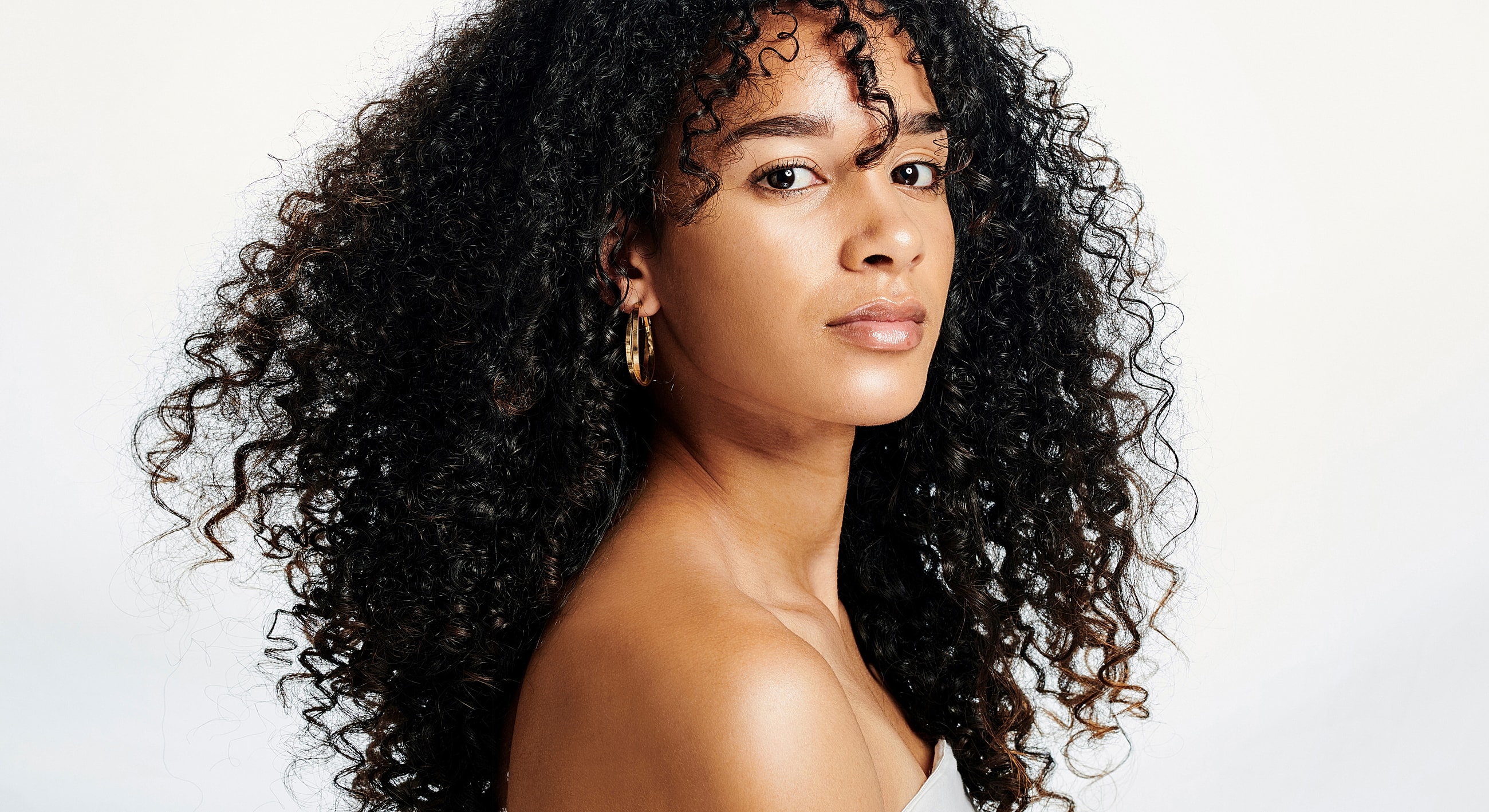 Portrait of a woman with curly hair.