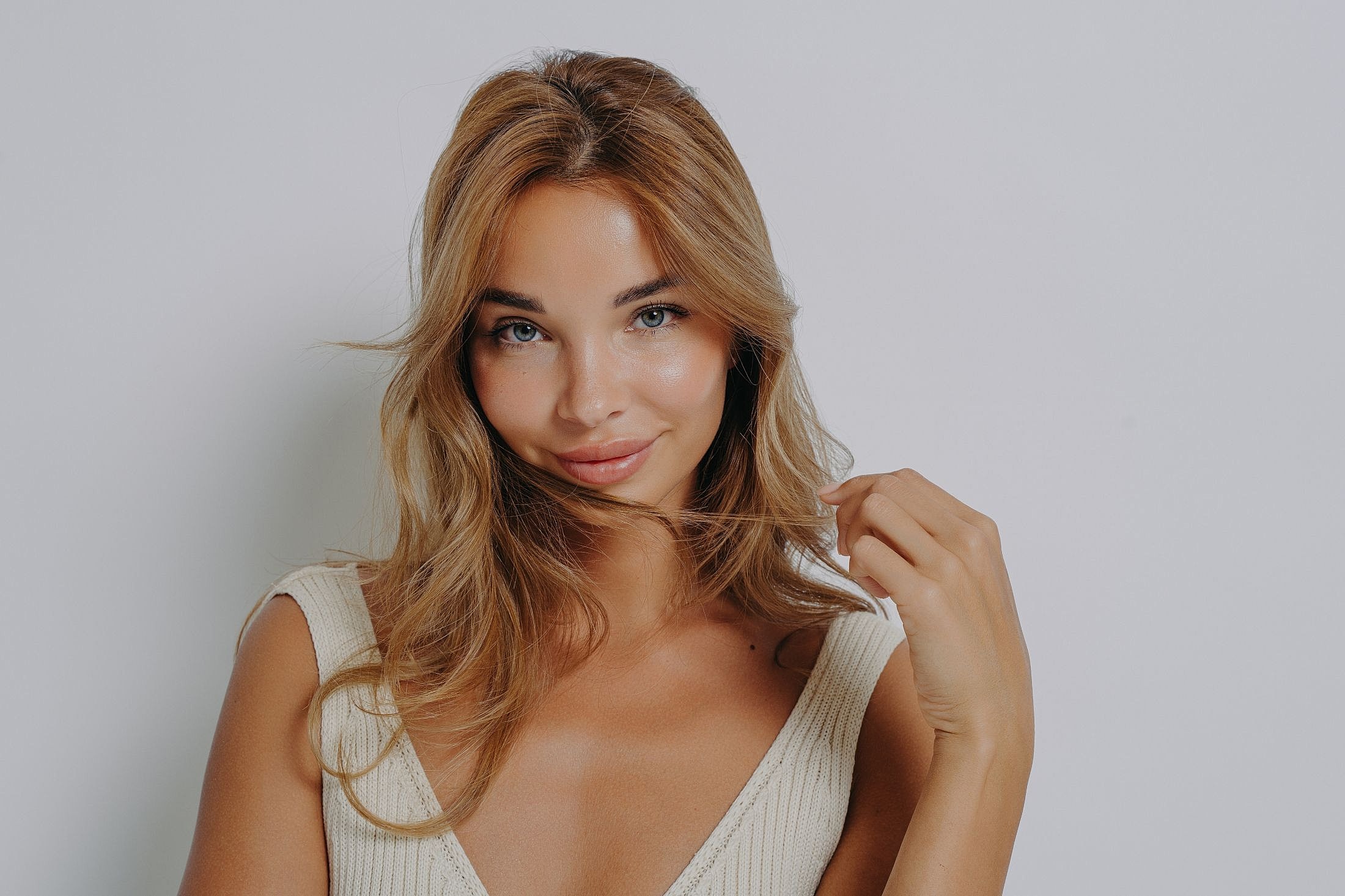 Smiling woman playing with her hair.